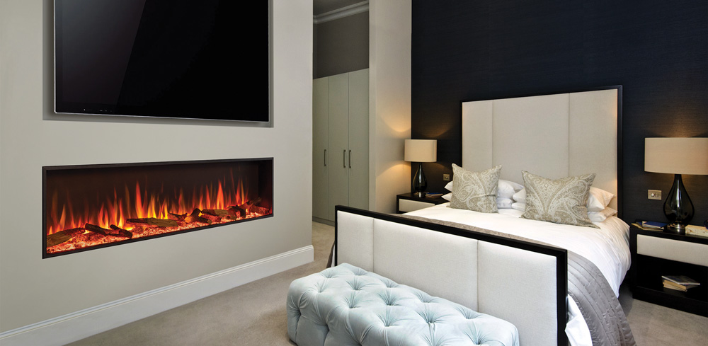 Prefabricated fireplace in a bedroom with electric on.
